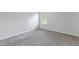 Bright bedroom with neutral carpeting, light gray walls, and a window at 129 Explorer Dr # 256, Morrisville, NC 27560