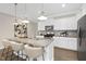 Bright kitchen features an island with seating, granite countertops, and stainless steel appliances at 129 Explorer Dr # 256, Morrisville, NC 27560
