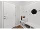 Welcoming mudroom with board and batten walls, bench, and coat hooks at 129 Explorer Dr # 256, Morrisville, NC 27560