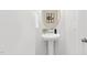Elegant powder room featuring a pedestal sink, modern fixtures, and a decorative mirror at 129 Explorer Dr # 256, Morrisville, NC 27560