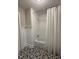 Bathroom featuring decorative floors and a white shower curtain and subway tile at 1300 Seabrook Ave, Cary, NC 27511