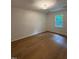 Bedroom featuring wood-look floors, single window, and updated lighting at 1300 Seabrook Ave, Cary, NC 27511