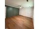 Large bedroom with wood-look flooring, ceiling fan, and double closets at 1300 Seabrook Ave, Cary, NC 27511