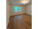 Bedroom with wood-look floors and natural light from two windows at 1300 Seabrook Ave, Cary, NC 27511