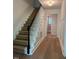 Home entryway featuring hardwood-style floors, a stairway, and classic trim at 1300 Seabrook Ave, Cary, NC 27511