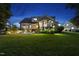 Well-lit backyard with a screened porch, manicured lawn, and inviting outdoor patio seating area at 1325 Mackinaw Dr, Wake Forest, NC 27587