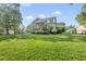 Expansive backyard featuring lush lawn, mature landscaping, and screened porch perfect for outdoor living at 1325 Mackinaw Dr, Wake Forest, NC 27587