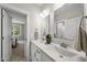 Elegant bathroom featuring double sinks, marble countertops, modern fixtures, and a connecting bedroom view at 1325 Mackinaw Dr, Wake Forest, NC 27587