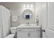 Well-lit bathroom with a marble vanity top, modern fixtures, a decorative mirror, and a clean, bright aesthetic at 1325 Mackinaw Dr, Wake Forest, NC 27587