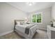 Bright bedroom featuring a plush bed, neutral décor, a large window with a view, and natural light at 1325 Mackinaw Dr, Wake Forest, NC 27587