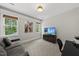 Bright bedroom featuring neutral walls, a comfortable seating area, and well-lit desk with backyard view at 1325 Mackinaw Dr, Wake Forest, NC 27587