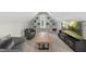 Cozy bonus room with comfortable seating, built-in shelves, and a large television for entertainment and relaxation at 1325 Mackinaw Dr, Wake Forest, NC 27587