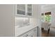 Convenient butler's pantry with white cabinetry, countertop space, and glass door upper cabinets at 1325 Mackinaw Dr, Wake Forest, NC 27587
