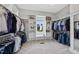 Spacious walk-in closet with custom shelving and a window offering natural light and neighborhood views at 1325 Mackinaw Dr, Wake Forest, NC 27587
