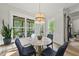 Cozy dining area features a round marble table, stylish lighting, and outdoor view at 1325 Mackinaw Dr, Wake Forest, NC 27587