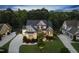 Beautiful exterior view of a home at twilight featuring stone accents and lush landscaping at 1325 Mackinaw Dr, Wake Forest, NC 27587