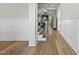 Elegant foyer with hardwood floors, white trim and wainscotting, leading to staircase and living area at 1325 Mackinaw Dr, Wake Forest, NC 27587