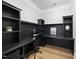 Dedicated home office featuring built-in shelving, ample workspace, and a sleek, modern design with hardwood floors at 1325 Mackinaw Dr, Wake Forest, NC 27587
