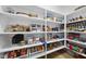 Pantry with wooden shelves and a variety of food items at 1325 Mackinaw Dr, Wake Forest, NC 27587
