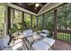 Screened porch with modern outdoor seating, a decorative rug, and a view of the backyard at 1325 Mackinaw Dr, Wake Forest, NC 27587