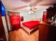 Bedroom with a cozy feel, with a red coverlet, and hardwood floors at 1337 Maple St, Rocky Mount, NC 27803
