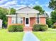 Charming single-story red brick home featuring a cozy front porch and well-maintained landscaping at 1337 Maple St, Rocky Mount, NC 27803