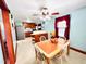 Eat-in kitchen featuring a ceiling fan, tile floors, and a dining table with matching chairs at 1337 Maple St, Rocky Mount, NC 27803