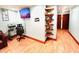 Inviting living room featuring laminate floors, a wall-mounted TV, and rustic decorative shelves at 1337 Maple St, Rocky Mount, NC 27803
