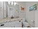 Stylish bathroom features a granite countertop, white vanity, and decorative wall art for a modern feel at 15 Smoketree Ct, Durham, NC 27712