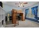 This bedroom features a wooden loft bed with a built in desk and a ceiling fan at 15 Smoketree Ct, Durham, NC 27712