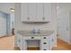 Built-in desk area with granite countertops, white cabinets, and black hardware offers a convenient workspace at 15 Smoketree Ct, Durham, NC 27712