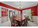 Formal dining room featuring a beautiful chandelier, decorative painting, a large table, and bright windows at 15 Smoketree Ct, Durham, NC 27712