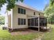 Rear view of the house showing the backyard, patio, and screened-in porch at 15 Smoketree Ct, Durham, NC 27712