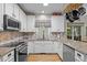 Well-appointed kitchen featuring stainless steel appliances, granite countertops, and ample cabinet space at 15 Smoketree Ct, Durham, NC 27712