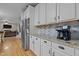Kitchen featuring granite countertops, stainless steel refrigerator, and view to the living room and staircase at 15 Smoketree Ct, Durham, NC 27712
