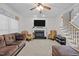 Spacious living room featuring a fireplace, a TV mounted above the mantel, and plush seating at 15 Smoketree Ct, Durham, NC 27712