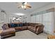 Bright living room with a large sectional couch, soft carpeting, and a view into the adjacent modern kitchen at 15 Smoketree Ct, Durham, NC 27712