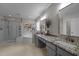 Large bathroom featuring double vanity, soaking tub, and glass shower enclosure, creating a spa-like experience at 15 Smoketree Ct, Durham, NC 27712