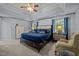 Spacious main bedroom with tray ceilings, carpeting, and large windows offers a relaxing retreat at 15 Smoketree Ct, Durham, NC 27712