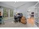 Bright home office features a large window, neutral carpeting, and a view into the living spaces at 15 Smoketree Ct, Durham, NC 27712
