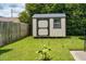 Backyard shed for extra storage, surrounded by lush green grass and a small banana plant at 1516 Greys Mill Rd, Rocky Mount, NC 27804