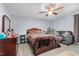 Bedroom featuring a ceiling fan, a sofa, and a dresser for ample storage at 1516 Greys Mill Rd, Rocky Mount, NC 27804