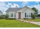 Charming single-story home with a well-manicured lawn and inviting red front door at 1516 Greys Mill Rd, Rocky Mount, NC 27804