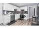 Modern kitchen featuring white cabinets, stone countertops, and stainless steel appliances at 1516 Greys Mill Rd, Rocky Mount, NC 27804