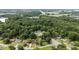 Aerial view showcases the neighborhood with mature trees, lawns, and surrounding greenery at 1713 Elder Ct, Burlington, NC 27215
