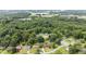 Aerial view of a neighborhood with mature trees, lawns, and surrounding commercial and highway areas at 1713 Elder Ct, Burlington, NC 27215