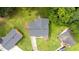 Aerial view of the house showcasing the roof, lawn, and surrounding landscape with mature trees at 1713 Elder Ct, Burlington, NC 27215