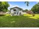 View of the expansive backyard with lush green grass and mature trees creating a private oasis at 1713 Elder Ct, Burlington, NC 27215