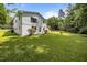 View of backyard showcasing the expansive yard with mature trees and house at 1713 Elder Ct, Burlington, NC 27215