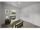 Cozy bedroom featuring neutral carpet, a framed window, and a twin bed with stylish green accents at 1713 Elder Ct, Burlington, NC 27215